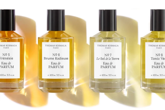 Four Thomas Kosmala Eau de Parfum bottles lined up, each with a black cap and white label featuring the fragrance name and volume.