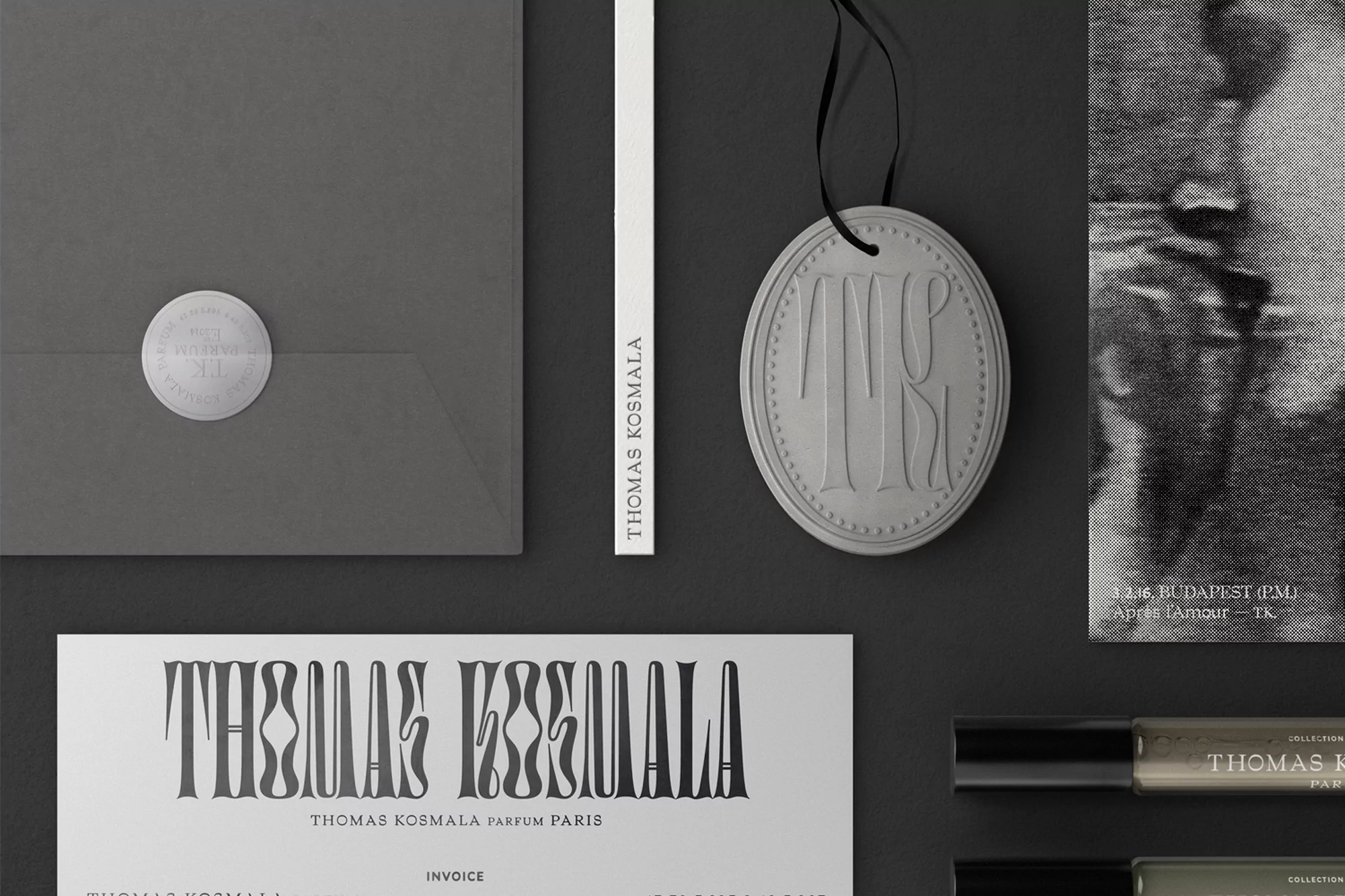 Flat lay of Thomas Kosmala brand marketing and product materials including stationery, product testers and a hanging ornament.
