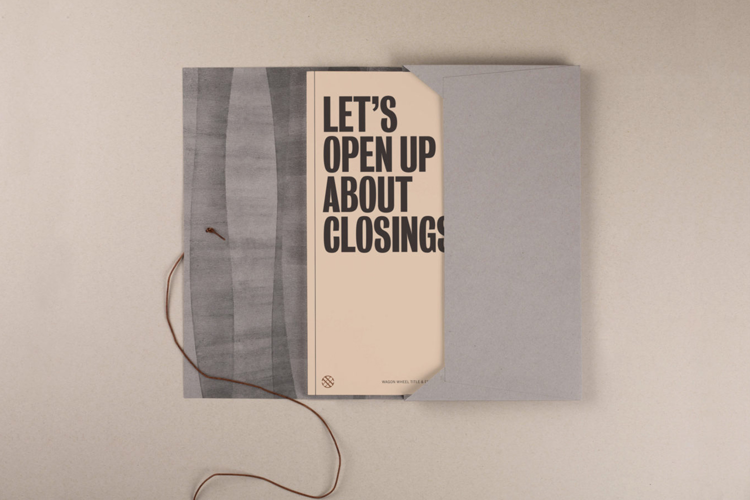 Square invite featuring stacked pages with the phrase, 'Let's Open Up About Closings,' and a string closure on a neutral surface.