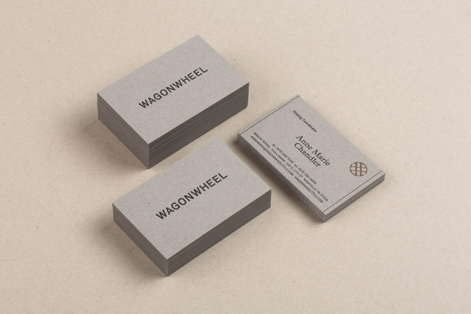 Stacks of grey business cards featuring the text "WAGONWHEEL" and contact information for Anne Marie Chandler, Catering Coordinator.