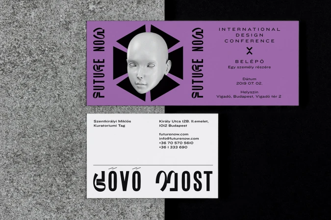Promotional materials: a lavender ticket with a mannequin head graphic, next to a white business card on a textured gray and black surface.