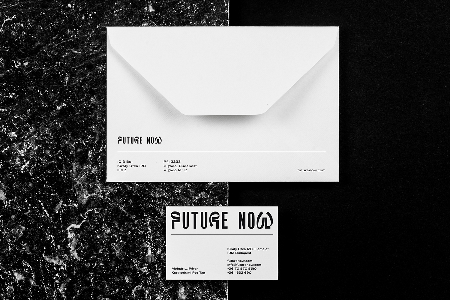 Elegant, minimalist branding mockup featuring a white envelope and business card on a black and marble background, showcasing a sleek, modern design.