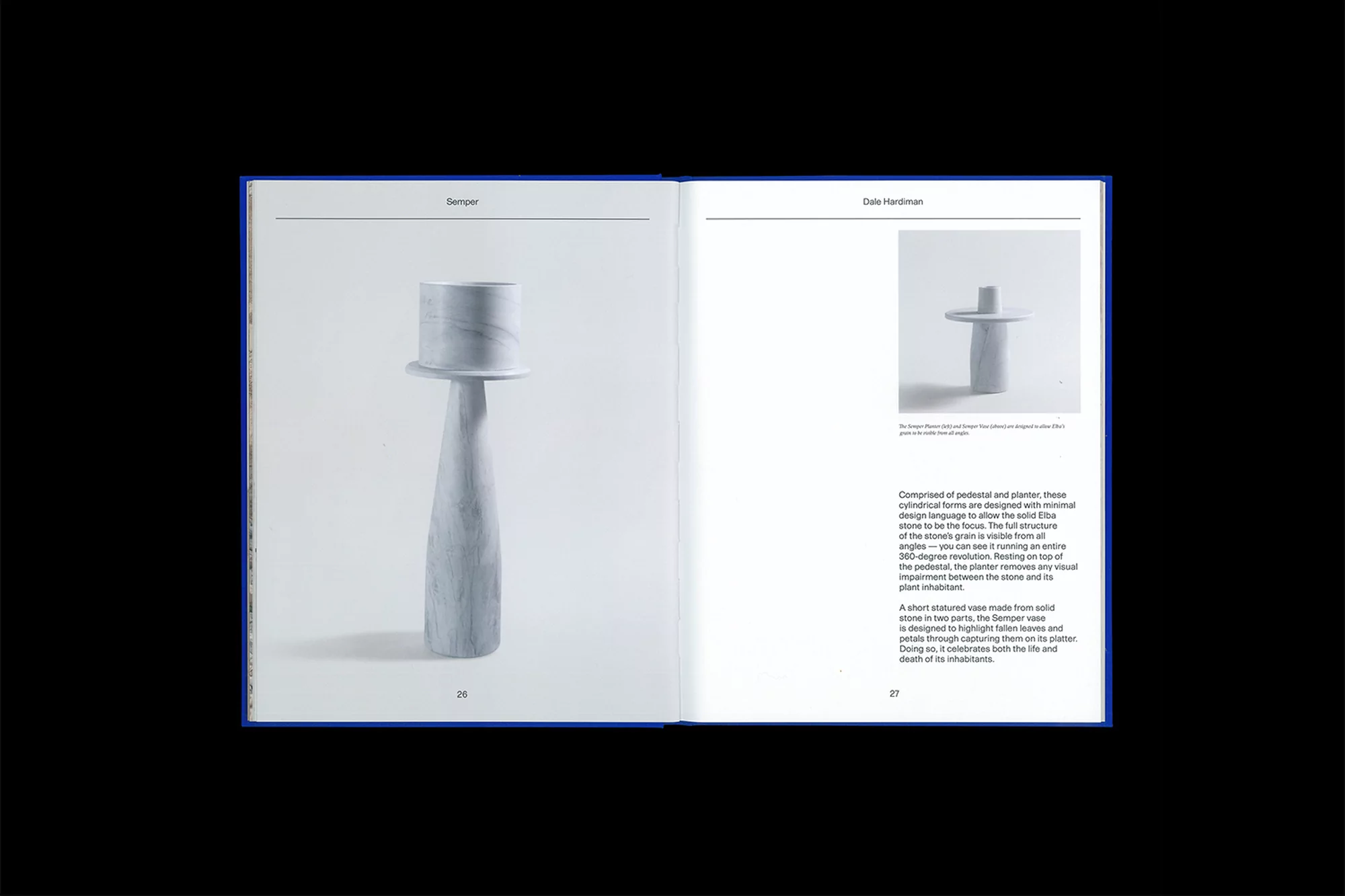 Open book displays two sculptures on white pages with blue borders, showcasing minimalist design and clean photography against a dark background.