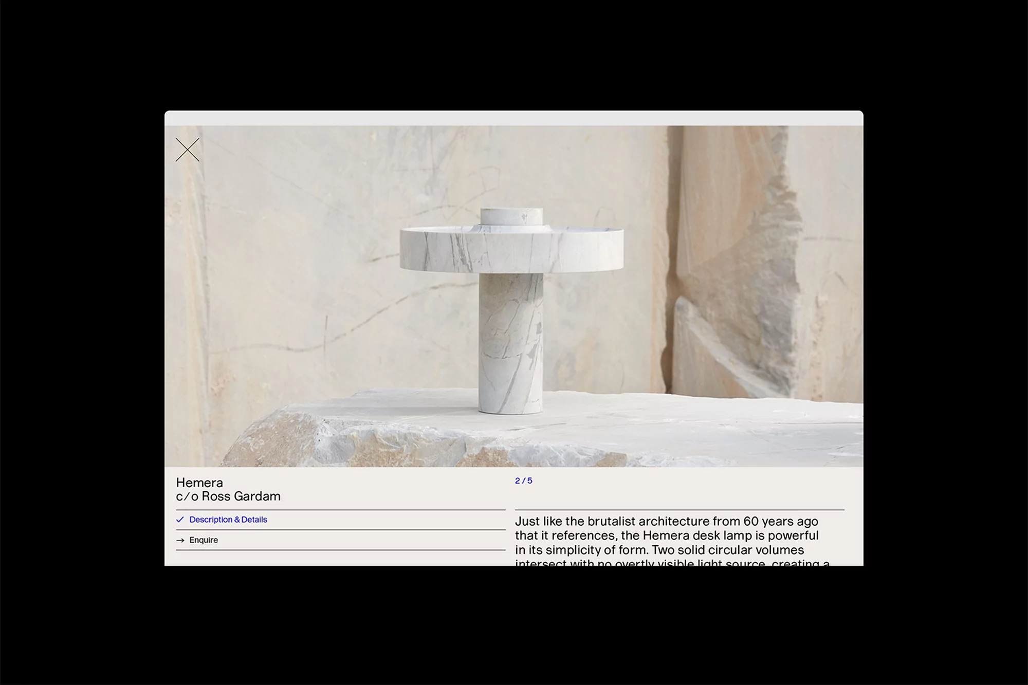 Minimalist table lamp made of white marble in a photo studio setting, showcasing modern lighting design and natural stone textures.