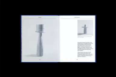 Open book spread showing a black and white photograph of a stone pedestal planter and descriptive typography text.