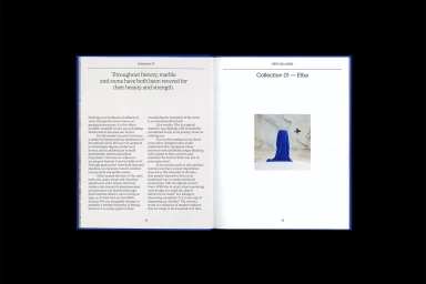 Open book spread showing typography on the left page and an inset photograph of a blue fabric-draped object on the right page.
