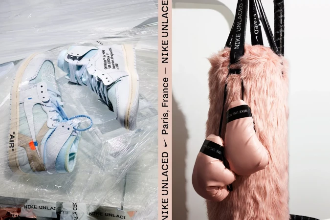 Two unwrapped Nike Unlaced Air Jordan 1 sneakers next to a pink fur punching bag with boxing gloves in a studio setting.