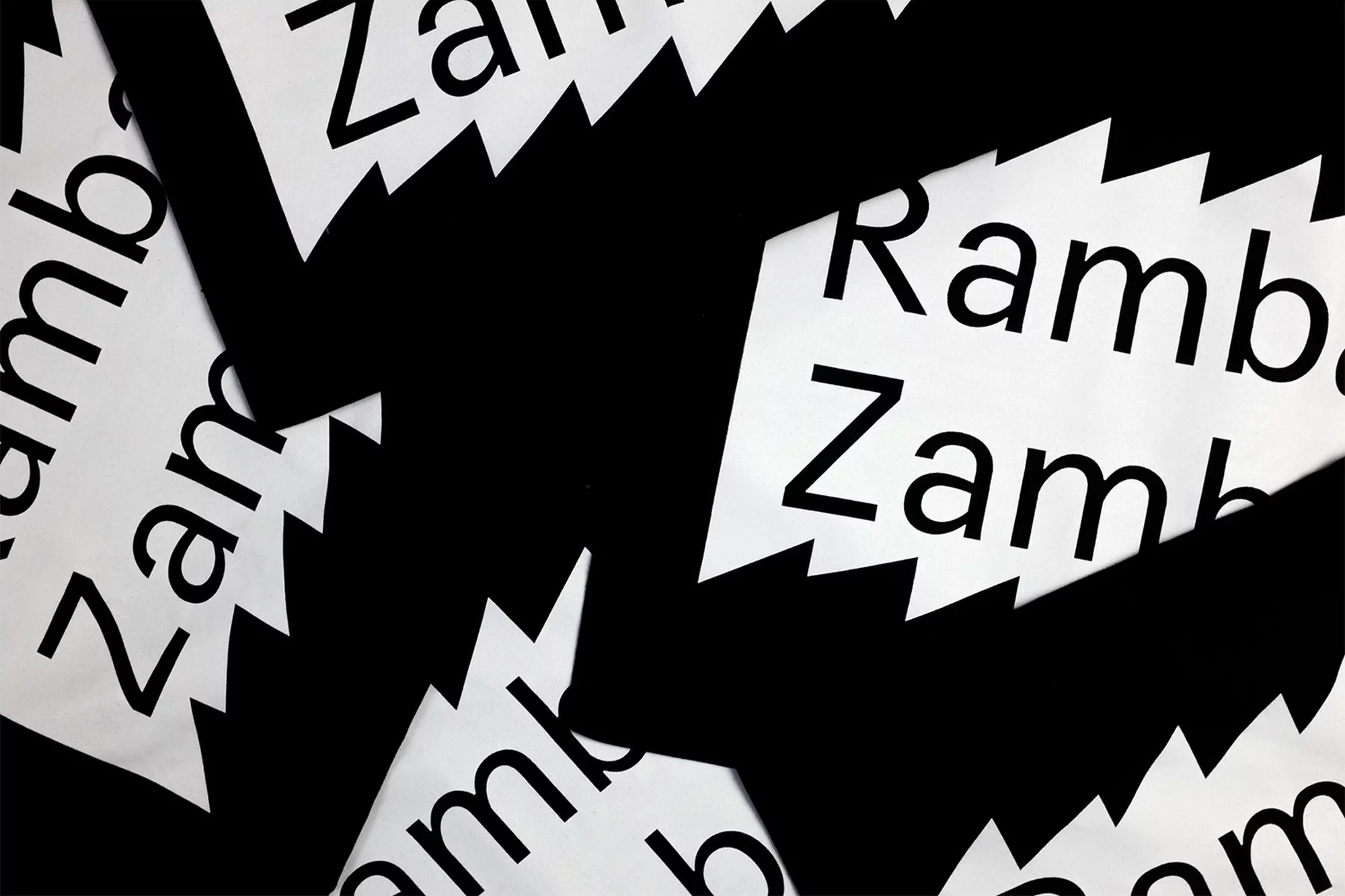 Abstract arrangement of black and white paper cutouts featuring jagged edges and the repeating text 'Zambia' and 'Rambala'.