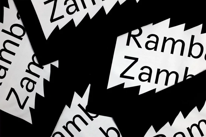 Abstract arrangement of black and white paper cutouts featuring jagged edges and the repeating text 'Zambia' and 'Rambala'.