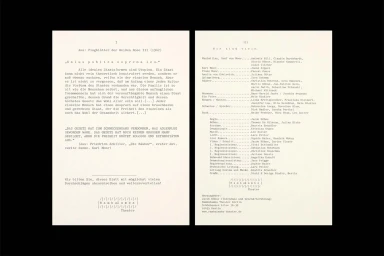 Open pages of a typewritten theatre programme with columns of text and cast credits on off-white paper.