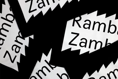 Close-up graphic design pattern featuring overlapping black and white elements with bold RambaZamba typography.