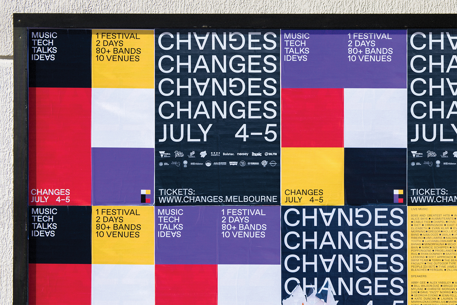 Multiple music festival posters with event details featuring stacked text and colorful geometric patterns, framed on an exterior wall.