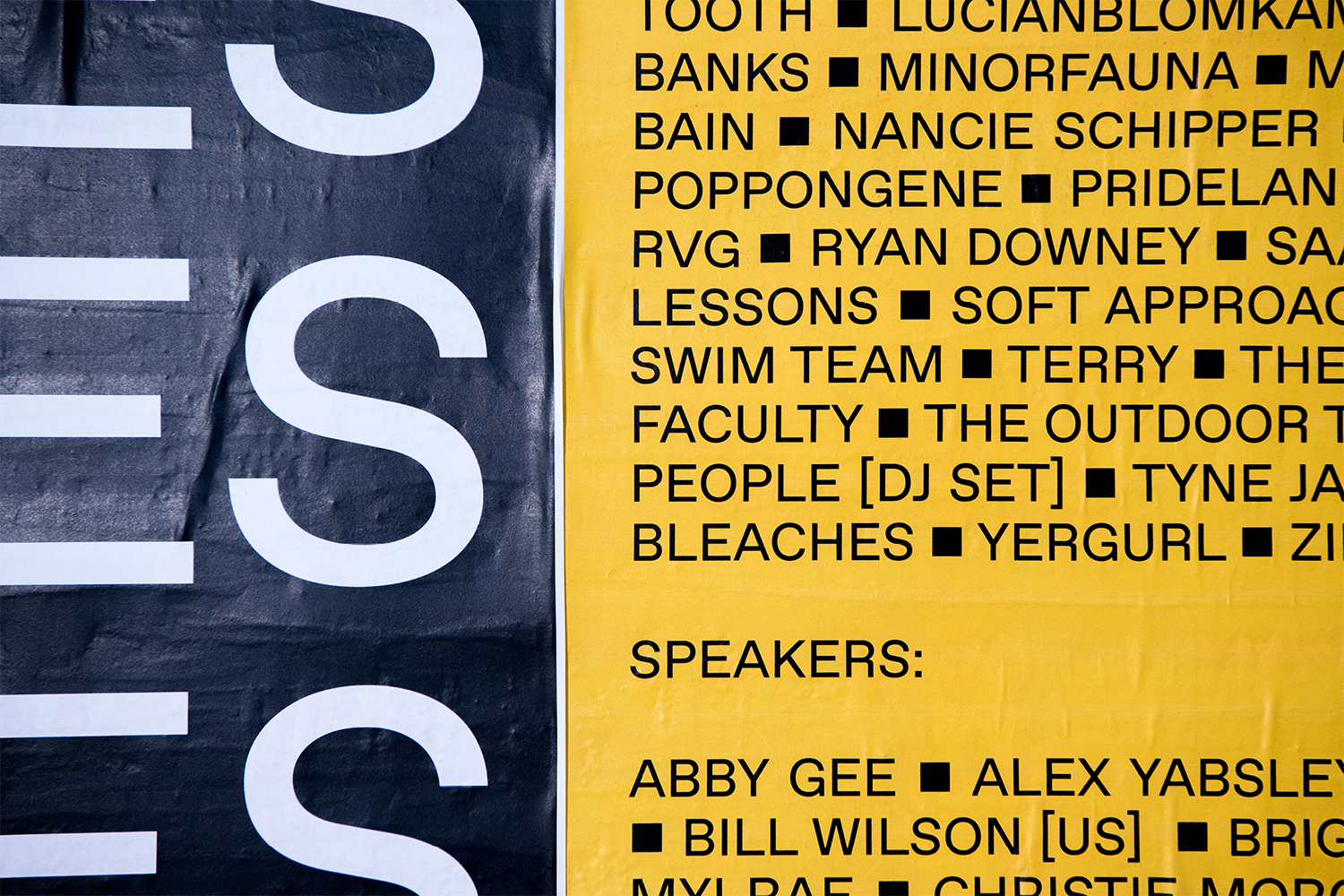 Promotional poster with large sans-serif letters on left side and yellow background with black text listing names on the right.