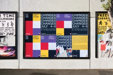 Changes festival posters featuring typographic grid designs pasted on an exterior textured wall