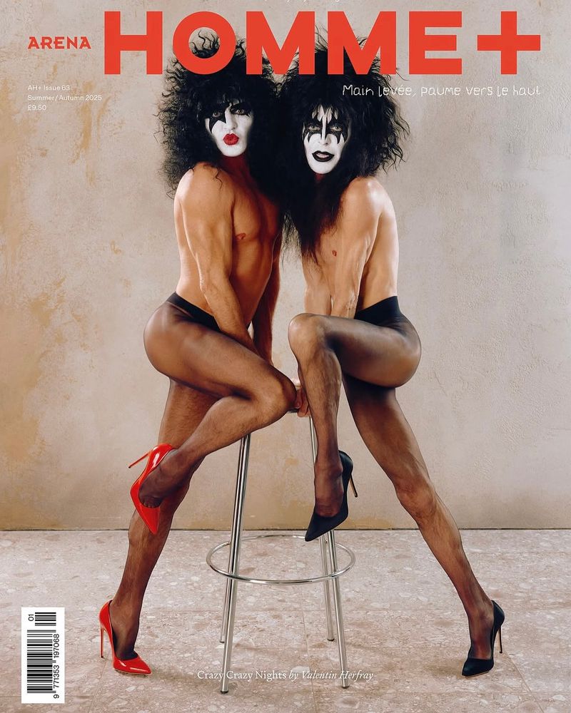 Arena Homme+ magazine cover featuring two bare-chested performers in black wigs, pantyhose, heels, and dramatic face makeup.