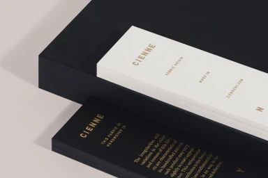 Cienne brand stationery and packaging including white and black cards with gold foil lettering