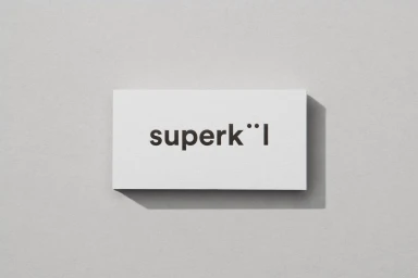 White rectangular business card featuring the black SuperKul brand logo, centered on a light grey textured background
