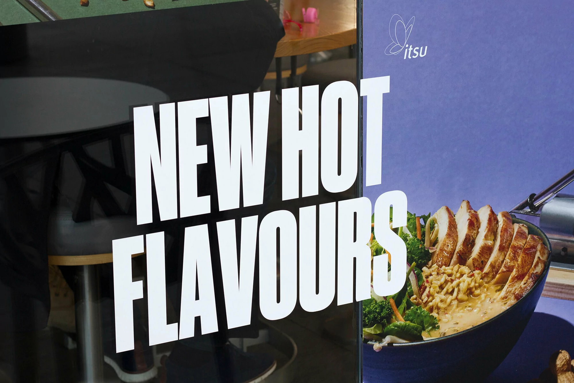 Bowl of ramen with chicken, broccoli, and carrots, featuring the Jitsu logo and bold text 'New Hot Flavours' against a blurred background.