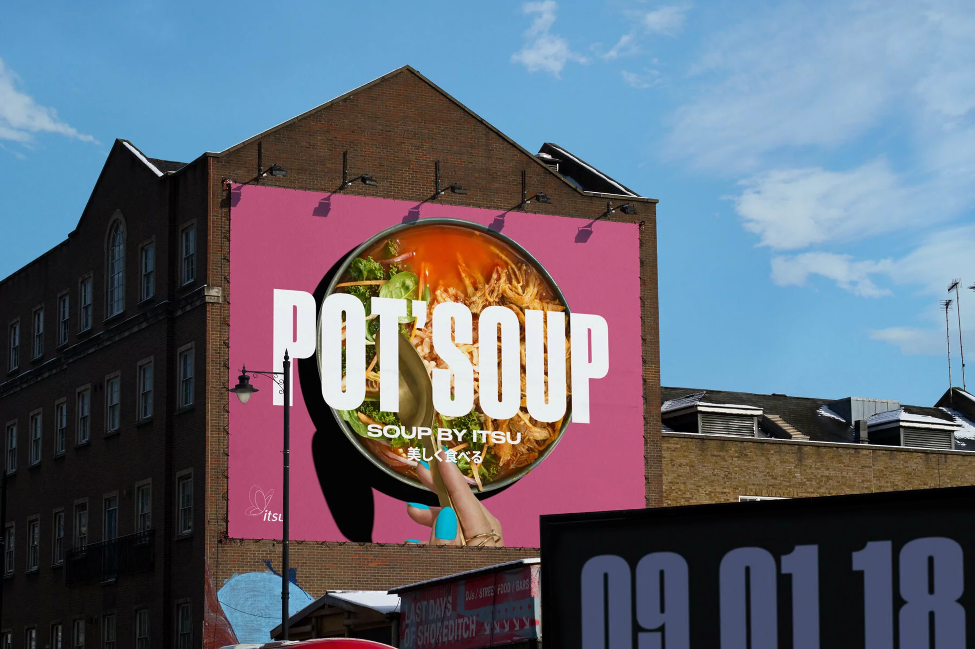Outdoor advertisement features an Itsou Pot's Soup billboard on a building, with vibrant food imagery and bold typography against a bright blue sky.