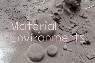 Text graphic reading Material Environments over textured grey clay and soil ground with spherical shapes
