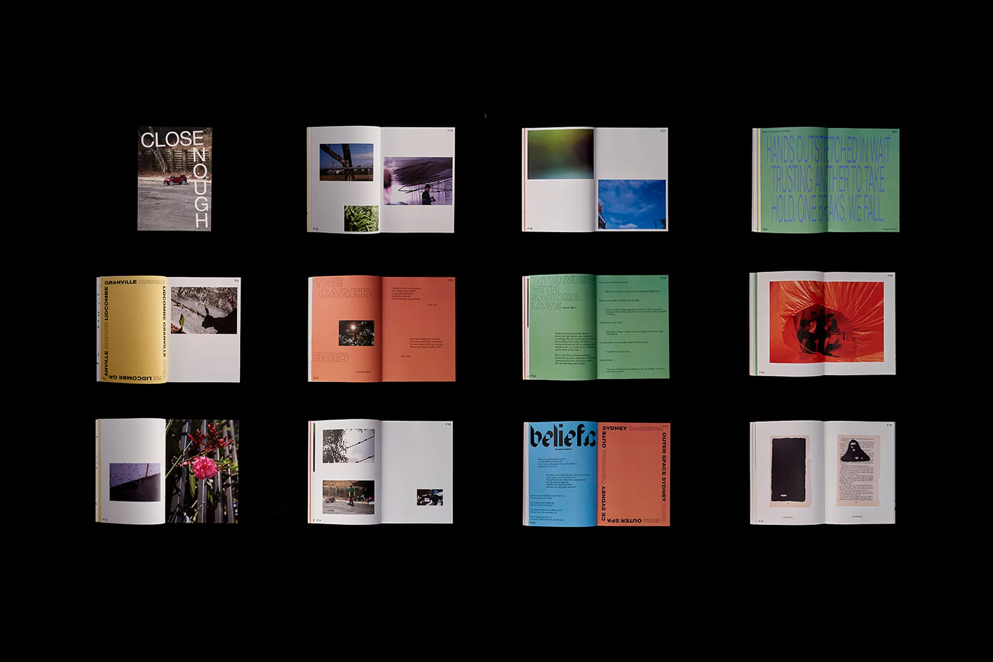 Collection of open books displaying various artwork, photography, and graphic design elements against a dark background.