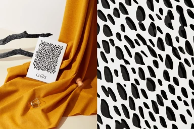 Split composition featuring draped mustard fabric with a card and cork next to a black and white organic spotted pattern