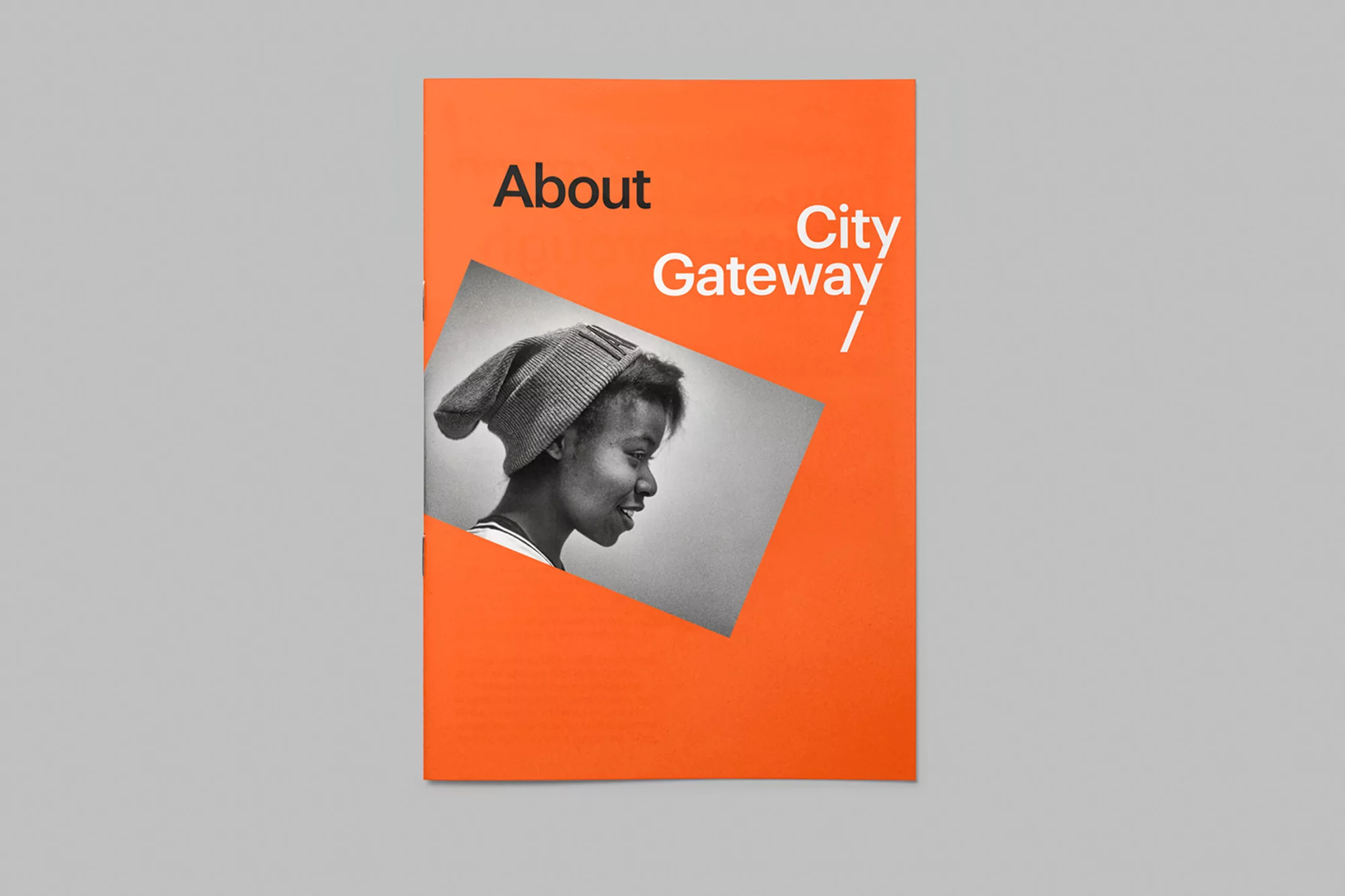 Book cover featuring a black and white portrait of a smiling young woman wearing a knit hat, with the words 'About City Gateway'.