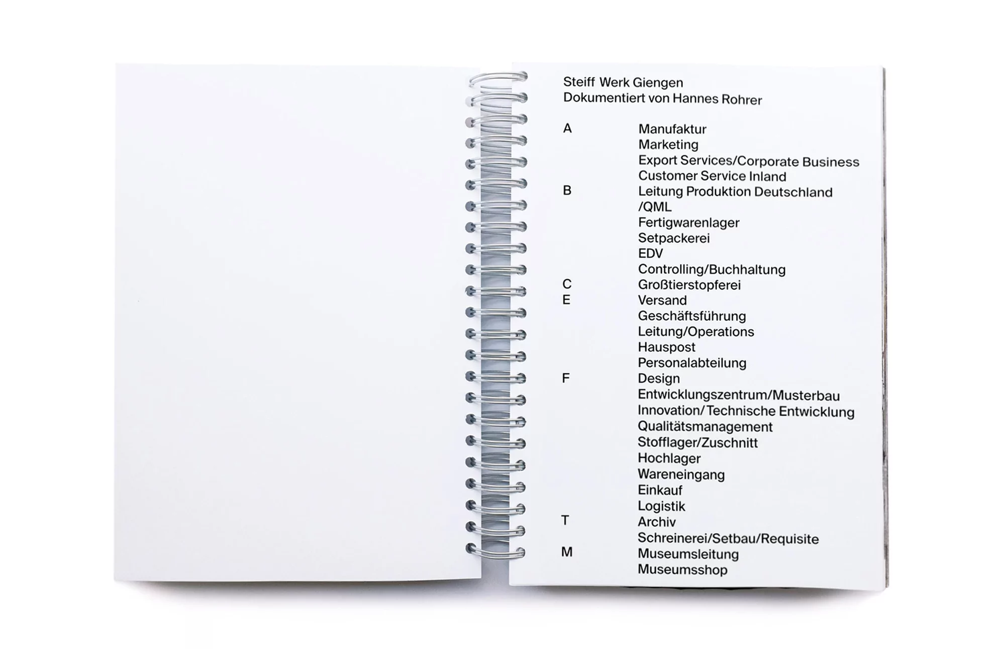 Open notebook featuring black text on white pages with a silver spiral binding, showcasing an organized compilation of information.
