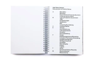 Open spiral-bound notebook showing a black and white typographic index page with department listings for Margarete Steiff GmbH