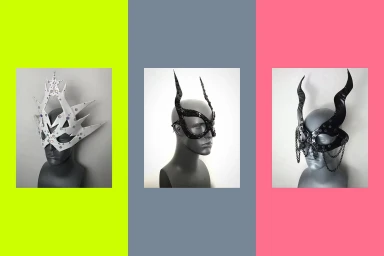 Three dark mannequins displaying elaborate horned and spiked headwear against vivid vertical colour-blocked backgrounds.