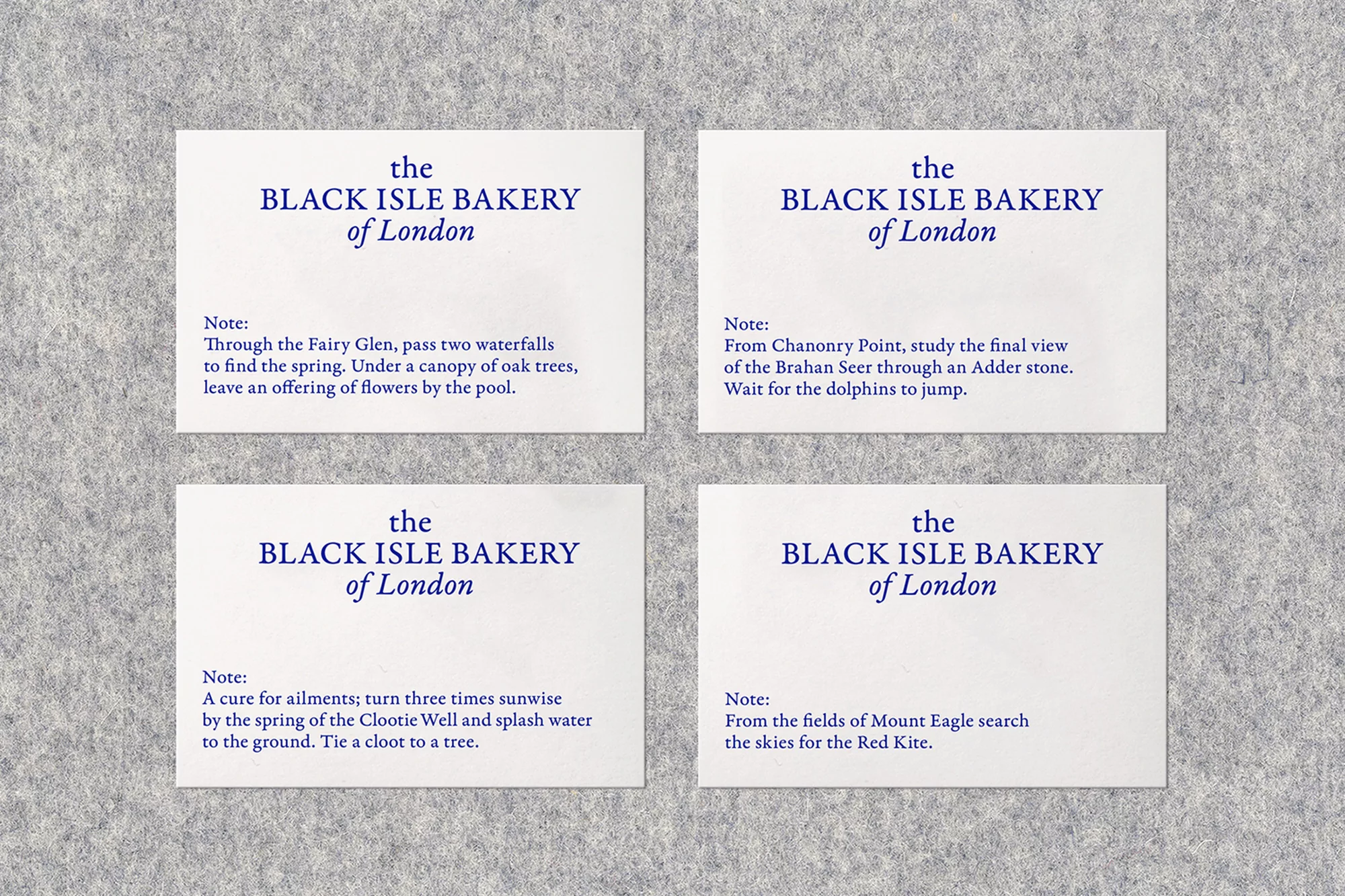 Four cards from The Black Isle Bakery of London on a gray felt background featuring textual descriptions and literary references.