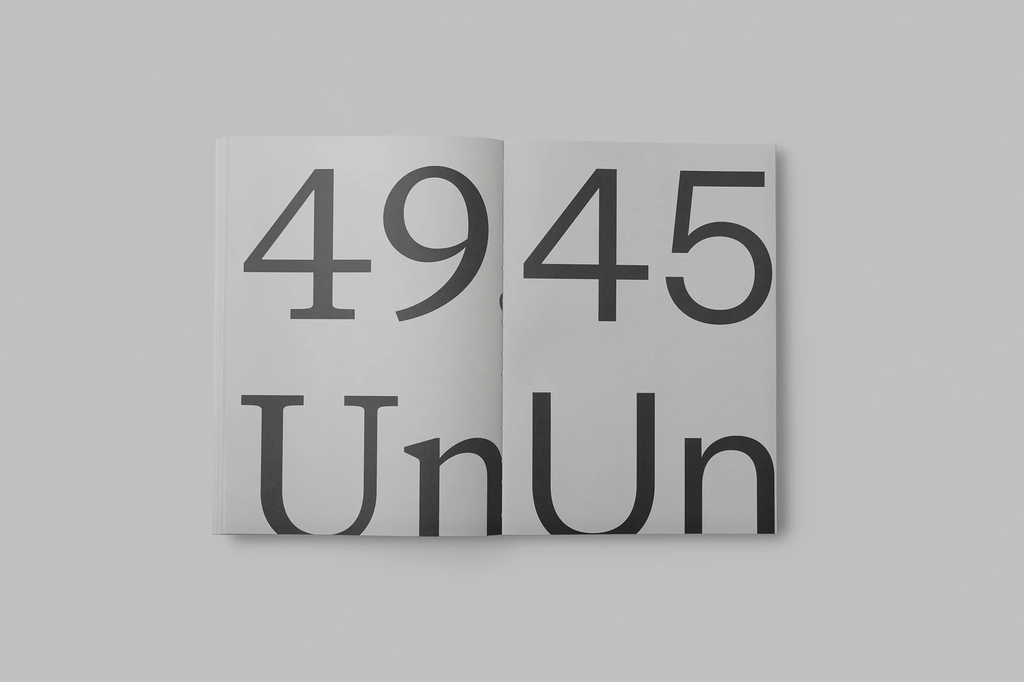 Open book displaying the numerals '4945' and the letters 'UnUn' in a large, bold, grey font on a white background.
