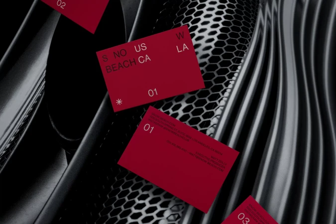 Eye-level shot of red cards with white text overlapping against a black and grey patterned background; the cards have the numbers 01-03.