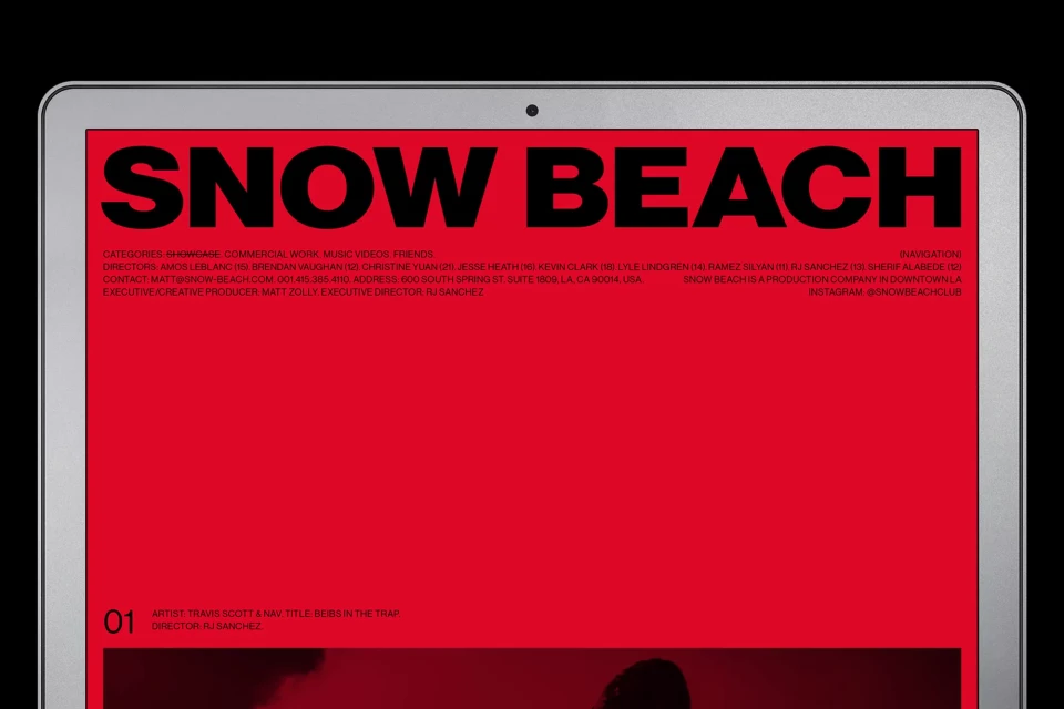 Website for Snow Beach production company displayed on an Apple laptop screen, set against a black background, simple composition.