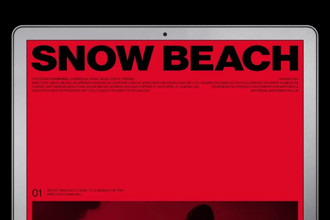 Website for Snow Beach production company displayed on an Apple laptop screen, set against a black background, simple composition.