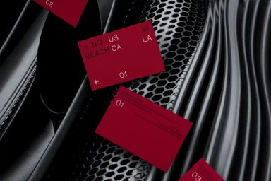 Red branded business cards floating over dark textured industrial metal surfaces and mesh background