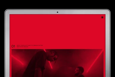 Laptop screen displaying Snow Beach brand identity with bold red UI elements and a music video still