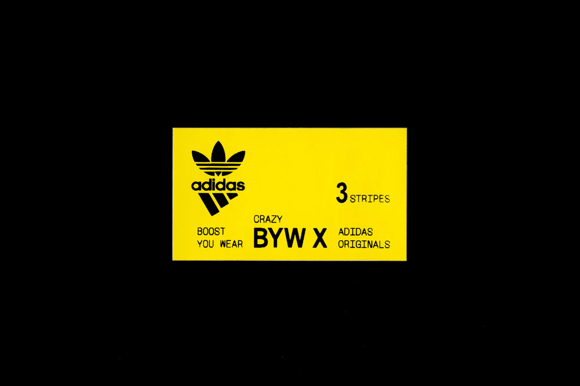 Adidas brand logo and text on a yellow rectangle against black background. Features the Adidas trefoil and '3 stripes' tagline.
