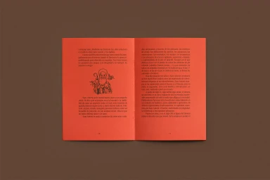 An open red booklet with printed Spanish text and illustration displayed flat against a solid brown background.