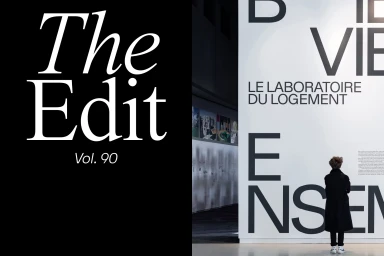 A person standing in front of a large display wall with bold typography reading Bien Vieillir Ensemble, next to a black panel with The Edit Vol. 90