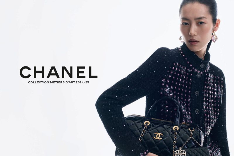 Asian model poses with a black Chanel purse and tweed jacket with sequins, set against a bright white background for a fashion advertisement.