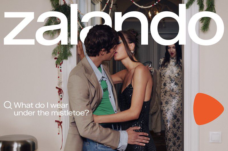 A romantic holiday-themed ad featuring a couple kissing under mistletoe near a third woman and a 'Zalando' logo.