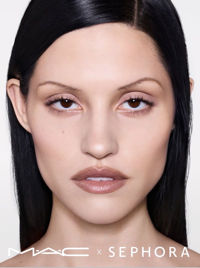 Close-up of a woman with neutral makeup posing against a bright white background in a beauty advertisement with MAC and Sephora logos.