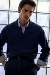 Model Justin Eric Martin wearing a dark blue knit polo shirt in a spring summer editorial for BOSS, photographed by Jeremy Everett.