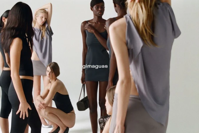 Diverse group of women in neutral-toned clothing posing in a bright photo studio. Fashion shoot emphasizing minimalist style and natural light.