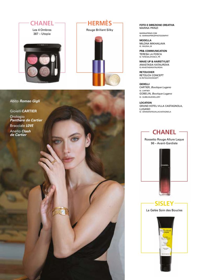 Advertisement featuring a woman with jewelry and makeup products from Chanel, Hermès, Sisley, and Cartier against a soft backdrop.