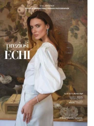 Woman in white puff-sleeve top and light-coloured skirt posing in front of a floral wall mural.