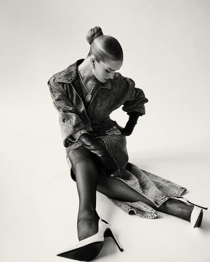Model Rosie Huntington-Whiteley wearing a denim coat and heels seated against a light background for Harper's Bazaar Taiwan