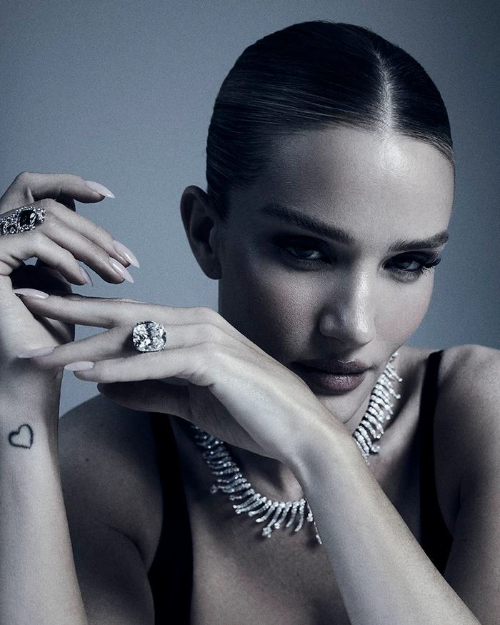 Model Rosie Huntington-Whiteley wearing diamond rings and necklace in a beauty editorial portrait by David Roemer.