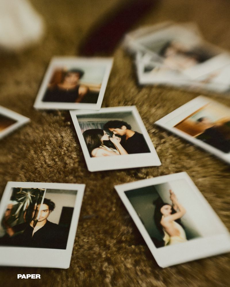 Several polaroid photographs on a brown, textured surface, featuring portraits of a couple and individual adults in indoor settings.